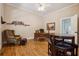 Lovely home office featuring hardwood flooring, bookshelves, and a comfortable seating area at 4200 E Highway 166 Rd, Carrollton, GA 30116