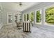 Sunroom features tile floors, many windows, and comfortable seating at 4200 E Highway 166 Rd, Carrollton, GA 30116