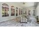 Bright sunroom features beautiful arched windows, tile flooring, and stylish furniture at 4200 E Highway 166 Rd, Carrollton, GA 30116