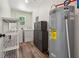 The functional utility room features washer, dryer, water heater, and built-in storage shelves at 4200 E Highway 166 Rd, Carrollton, GA 30116