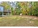 Expansive backyard featuring a deck and mature trees, perfect for outdoor activities at 6765 Crofton Dr, Alpharetta, GA 30005