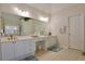 Bright bathroom with double vanity, a large mirror, and tile flooring at 6765 Crofton Dr, Alpharetta, GA 30005