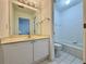 A clean bathroom featuring white tiled walls and a tub-shower combination at 6765 Crofton Dr, Alpharetta, GA 30005