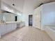 Expansive primary bathroom with double vanity, tiled floors and garden tub at 6765 Crofton Dr, Alpharetta, GA 30005
