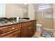 Primary bathroom with dark wood cabinets, black granite counters, and a glass shower enclosure at 6765 Crofton Dr, Alpharetta, GA 30005