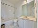 Clean bathroom with white tile, a shower-tub combination, and a single sink vanity at 6765 Crofton Dr, Alpharetta, GA 30005
