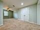 Spacious bedroom with carpet, ceiling fan, and double door closet at 6765 Crofton Dr, Alpharetta, GA 30005