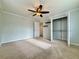 Cozy bedroom featuring plush carpeting, closet with custom shelving and ceiling fan at 6765 Crofton Dr, Alpharetta, GA 30005