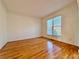 Clean and spacious bedroom featuring hardwood floors, neutral walls, and a large window at 6765 Crofton Dr, Alpharetta, GA 30005