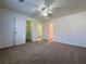 A spacious bedroom featuring neutral carpeting and a ceiling fan at 6765 Crofton Dr, Alpharetta, GA 30005