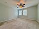 Bright and airy bedroom featuring plush carpet, ceiling fan, and natural light at 6765 Crofton Dr, Alpharetta, GA 30005