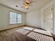 A well-lit bedroom with sunlight streaming through the window and neutral colored carpet at 6765 Crofton Dr, Alpharetta, GA 30005