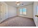 A bedroom with natural light coming in the window, and neutral colored carpeting at 6765 Crofton Dr, Alpharetta, GA 30005