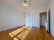 Bright bedroom featuring hardwood floors, a ceiling fan, and ample closet space with natural light at 6765 Crofton Dr, Alpharetta, GA 30005