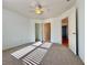 A bedroom featuring neutral carpet, doors to bathroom and closet, and a ceiling fan at 6765 Crofton Dr, Alpharetta, GA 30005