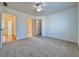 A bedroom with doors to closet and bathroom, and neutral colored carpeting at 6765 Crofton Dr, Alpharetta, GA 30005