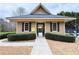 Exterior view of clubhouse entrance leading to a private, manicured garden at 6765 Crofton Dr, Alpharetta, GA 30005