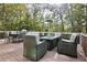 Inviting deck with an outdoor dining set and comfortable seating, nestled amongst trees for a private retreat at 6765 Crofton Dr, Alpharetta, GA 30005