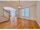 Light-filled dining room featuring hardwood floors, wainscoting, and a classic chandelier with a tray ceiling at 6765 Crofton Dr, Alpharetta, GA 30005