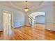 Formal dining room with hardwood floors, wainscoting, and an elegant chandelier under a tray ceiling at 6765 Crofton Dr, Alpharetta, GA 30005