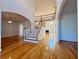 Spacious entryway with hardwood floors, stairs, and a view into the dining room and living area at 6765 Crofton Dr, Alpharetta, GA 30005