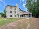 Well-maintained home featuring a covered patio and lush backyard at 6765 Crofton Dr, Alpharetta, GA 30005