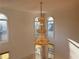 Elegant foyer showcases a tiered chandelier and abundant natural light from arched windows at 6765 Crofton Dr, Alpharetta, GA 30005