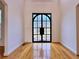 Foyer showcasing a statement steel and glass front door and hardwood floors at 6765 Crofton Dr, Alpharetta, GA 30005