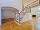 Elegant foyer showcasing hardwood floors, a staircase, and an arched entryway to the dining room at 6765 Crofton Dr, Alpharetta, GA 30005