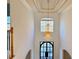 Grand foyer with a soaring ceiling, a stunning chandelier, and an elegant front door at 6765 Crofton Dr, Alpharetta, GA 30005