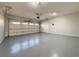 Spacious garage featuring a painted floor, overhead door, and ample space for vehicles and storage at 6765 Crofton Dr, Alpharetta, GA 30005