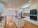 Open-concept kitchen with an island, stainless appliances, and hardwood floors at 6765 Crofton Dr, Alpharetta, GA 30005