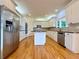 Lovely kitchen features an island, granite countertops, stainless steel appliances, and lots of natural light at 6765 Crofton Dr, Alpharetta, GA 30005