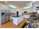 Well-lit kitchen with stainless steel appliances, center island, and granite countertops at 6765 Crofton Dr, Alpharetta, GA 30005