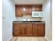 Stylish kitchenette features granite counters, custom cabinets, undermount sink, and microwave at 6765 Crofton Dr, Alpharetta, GA 30005