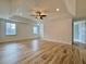 Bright living room with wood-look tile floors, recessed lighting, and ceiling fan at 6765 Crofton Dr, Alpharetta, GA 30005