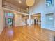 Spacious living room with hardwood floors, staircase, and an open view of the kitchen at 6765 Crofton Dr, Alpharetta, GA 30005