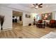 Open-concept living room with tray ceilings, crown molding, and wood-look tile flooring at 6765 Crofton Dr, Alpharetta, GA 30005