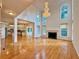 Bright open-concept living room features hardwood floors, a fireplace, and large windows at 6765 Crofton Dr, Alpharetta, GA 30005