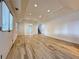 Spacious living room with wood-look tile floors, recessed lighting, and ample natural light at 6765 Crofton Dr, Alpharetta, GA 30005