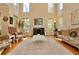 Bright living room with high ceilings, many windows, and a fireplace at 6765 Crofton Dr, Alpharetta, GA 30005