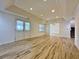 A finished basement area with tile flooring, recessed lighting, and a staircase at 6765 Crofton Dr, Alpharetta, GA 30005
