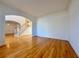 Open-concept living area featuring hardwood floors, crown molding, and a staircase with white rails at 6765 Crofton Dr, Alpharetta, GA 30005
