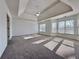 Expansive primary bedroom featuring carpet, recessed lights, a ceiling fan and multiple windows at 6765 Crofton Dr, Alpharetta, GA 30005