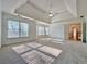 Bright main bedroom with tray ceiling, carpeted floors, and multiple windows for ample light at 6765 Crofton Dr, Alpharetta, GA 30005