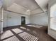 Large main bedroom with tray ceiling, carpet, and a window with natural light at 6765 Crofton Dr, Alpharetta, GA 30005
