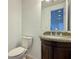 A powder room with a decorative vanity and a granite countertop at 6765 Crofton Dr, Alpharetta, GA 30005