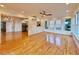 Light-filled sunroom with hardwood floors, ceiling fan, and multiple windows overlooking the backyard at 6765 Crofton Dr, Alpharetta, GA 30005
