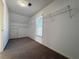 Carpeted walk-in closet with shelving, window and small access door at 6765 Crofton Dr, Alpharetta, GA 30005