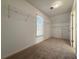 Walk-in closet with carpeted floor, window, and wire shelving for optimal storage at 6765 Crofton Dr, Alpharetta, GA 30005